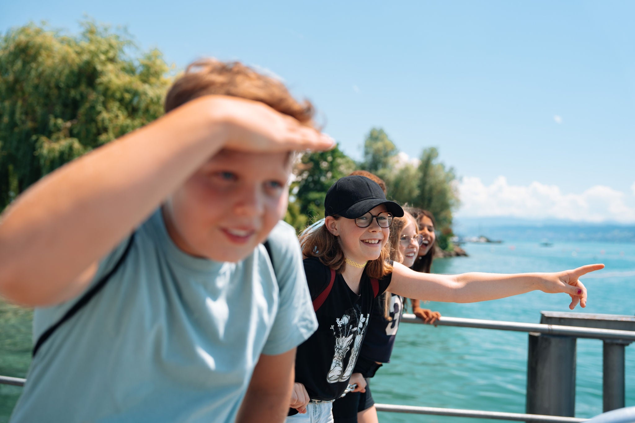 Eine Kindergruppe schaut vorfreudig auf das anfahrende Schiff. 