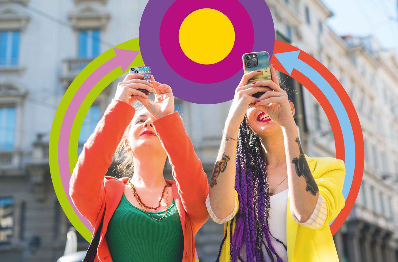 Zwei Freundinnen machen mit ihren Smartphones Fotos in einer urbanen Umgebung. Im Hintergrund sind farbige ZVV-Grafikelemente.
