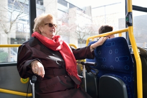 Elderly lady sitting in a bus.